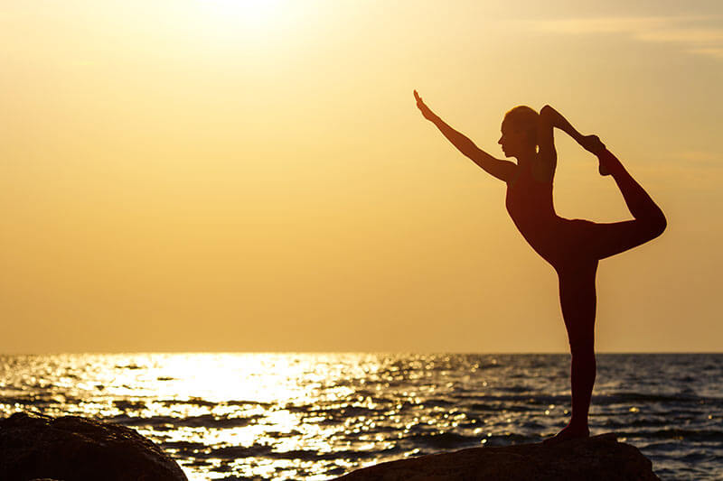 Yoga or Meditation at Sunrise by the Ocean