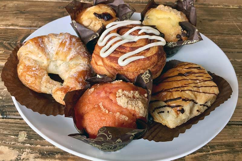 A plate of breakfast pastries on a wood table