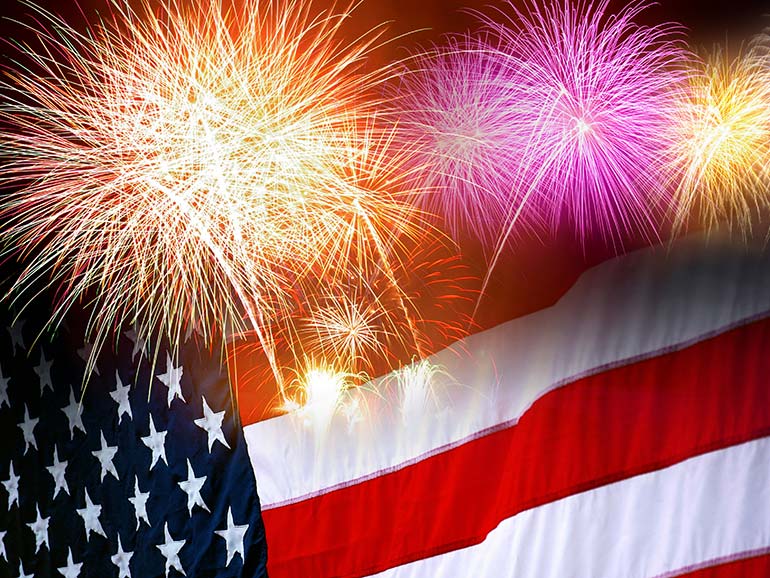 Fireworks and Flag Fireworks in front of American Flag