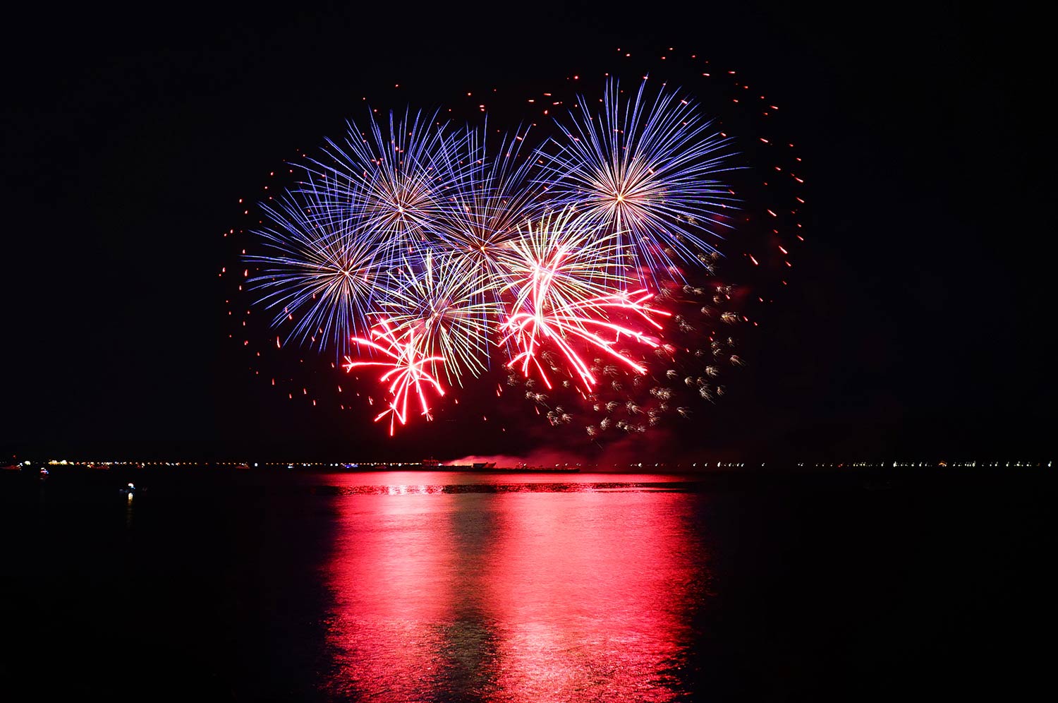 Red-And-Blue-Fireworks-Over-Water Red and blue fireworks over water