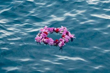 Wreath of flowers floating on the ocean for burial at sea