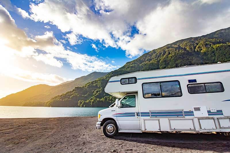 RV Motorhome An RV motorhome parked near a body of water