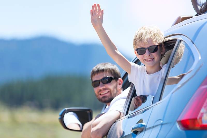 Family on Road Trip A man and a boy in a car on a road trip