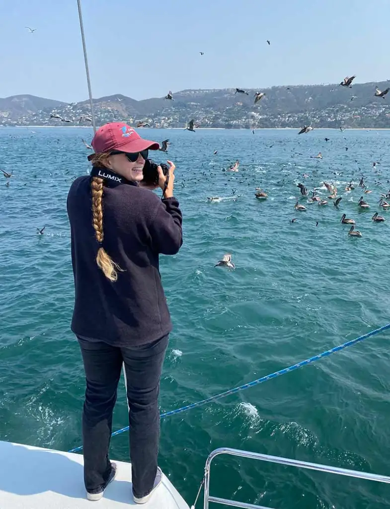 a person standing next to a body of water