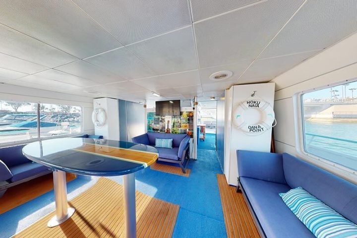 Sofas and surfboard table on main deck of Hoku Nai'a Whale Watching Power Catamaran off the coast of Dana Point, CA