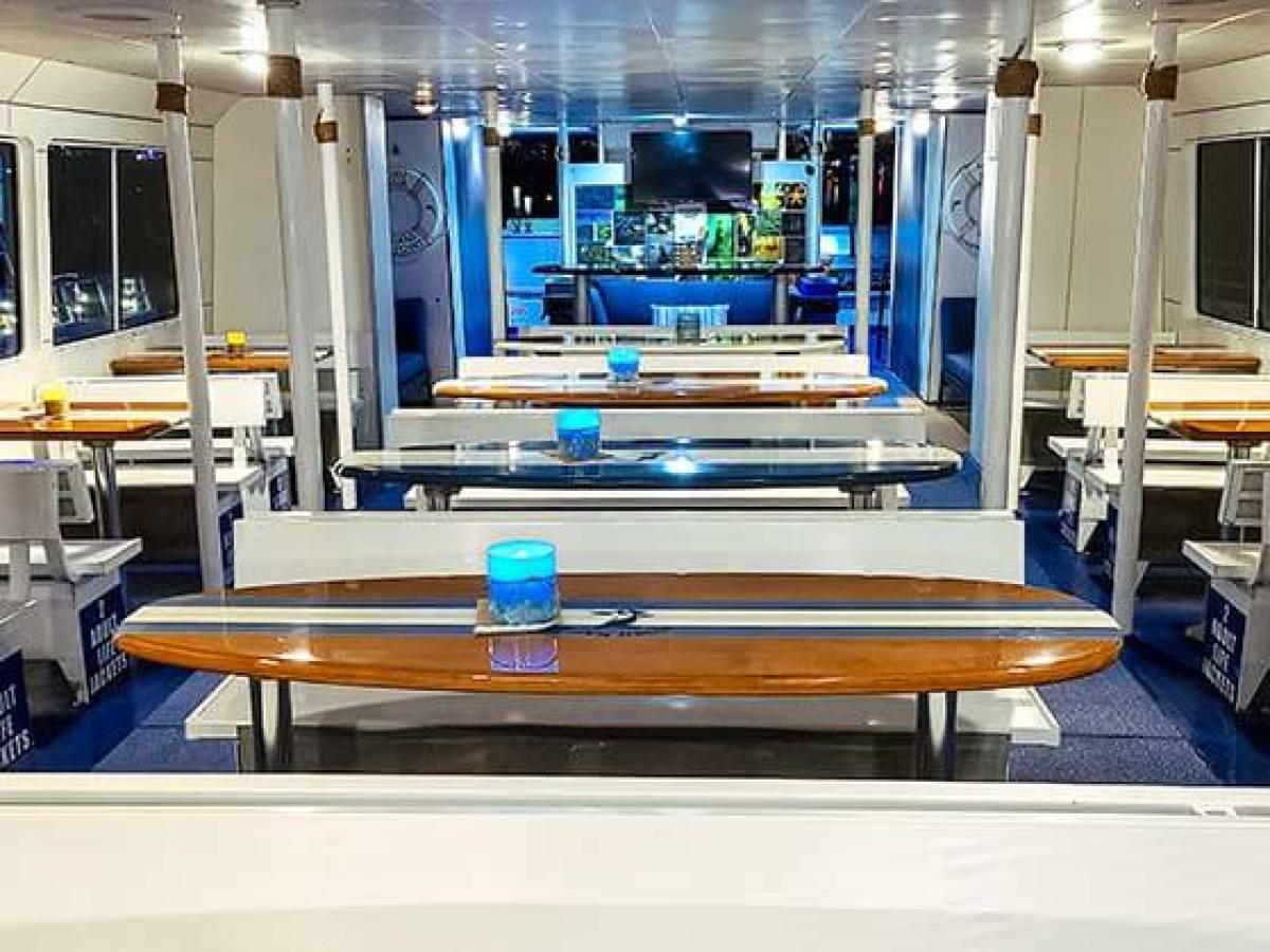 Bench seating with surfboard tables on main deck of Hoku Nai'a Whale Watching Power Catamaran off the coast of Dana Point, CA