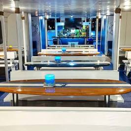 Bench seating with surfboard tables on main deck of Hoku Nai'a Whale Watching Power Catamaran off the coast of Dana Point, CA