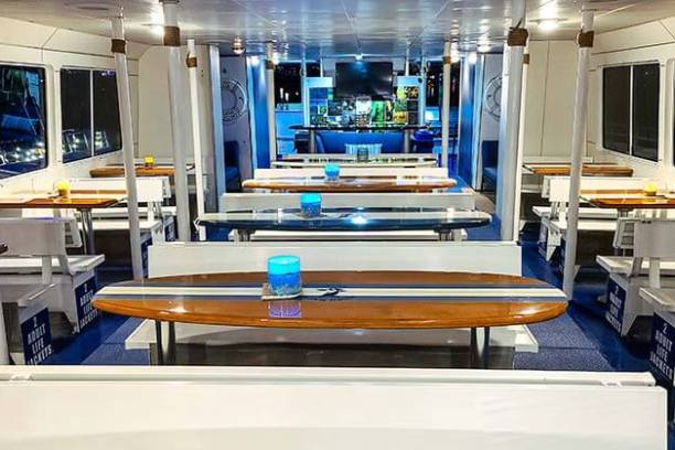Bench seating with surfboard tables on main deck of Hoku Nai'a Whale Watching Power Catamaran off the coast of Dana Point, CA