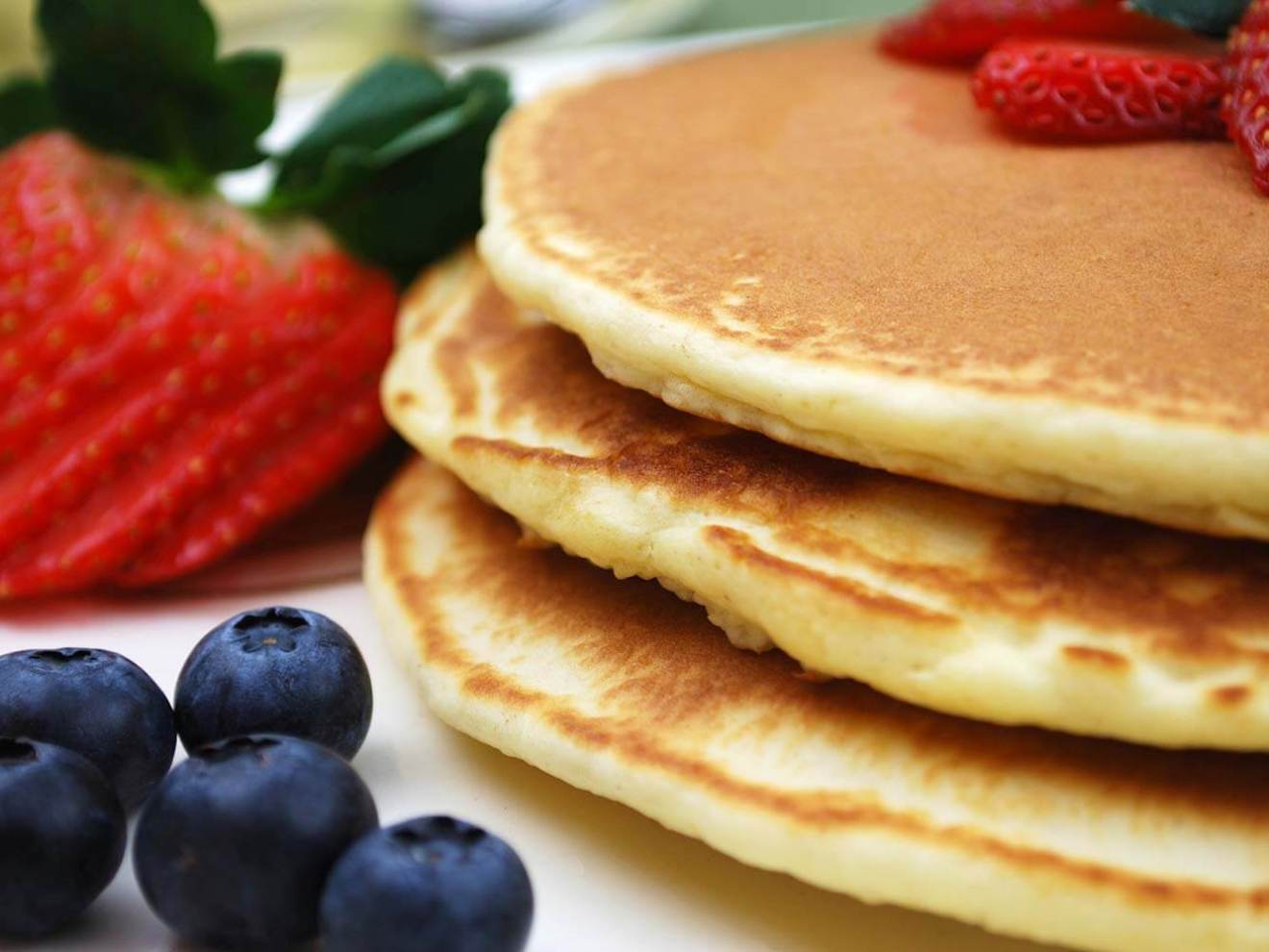 Brunch pancakes with strawberries and blueberries