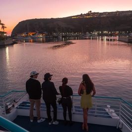 Guests enjoy the sunset during party boat cruise in Dana Point Harbor
