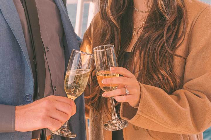 Champagne toast during marriage proposal at sea on a yacht off the coast of Dana Point, California