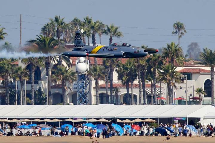a group of people standing around a plane
