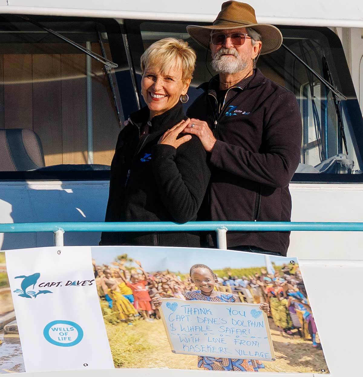 Wells-of-Life_Dave-and-Gisele_1200x1245 Captain Dave and Gisele with Wells of Life Thank You Sign