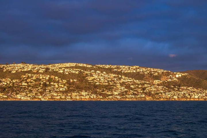 A golden sunset lights up the coastline of Orange County, near Dana Point, known as the California Riviera