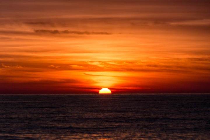 A bold orange sunset at sea off the coast of Dana Point, California